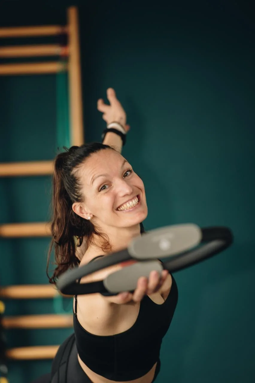 Portrait de Nolwenn Cadiou souriante, tenant un cercle de Pilates